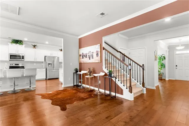 a view of a dining room with furniture and wooden floor