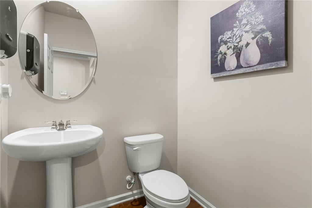 1476 Harlequin Way Stockbridge, GA 30281 - Photo 31 of 62 a bathroom with a toilet sink and mirror