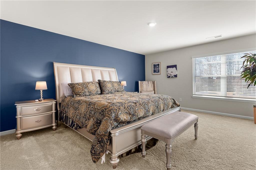 1476 Harlequin Way Stockbridge, GA 30281 - Photo 36 of 57 a bedroom with a bed and a table