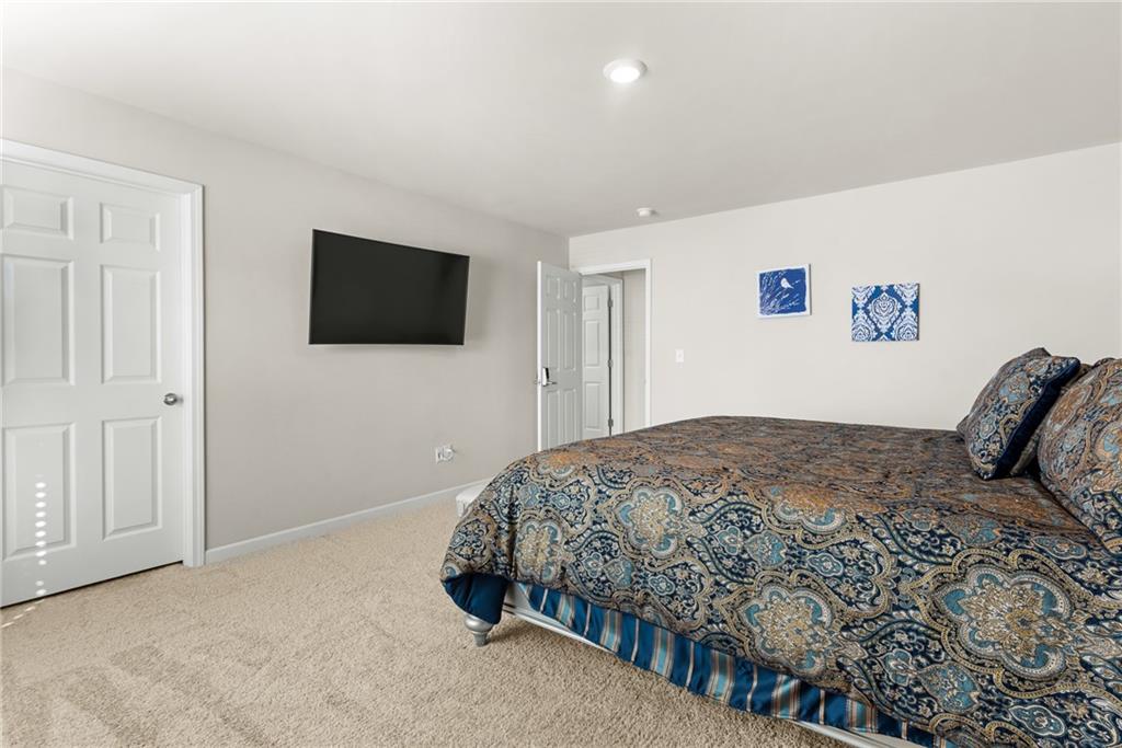 1476 Harlequin Way Stockbridge, GA 30281 - Photo 37 of 57 a bedroom with a bed and a flat screen tv