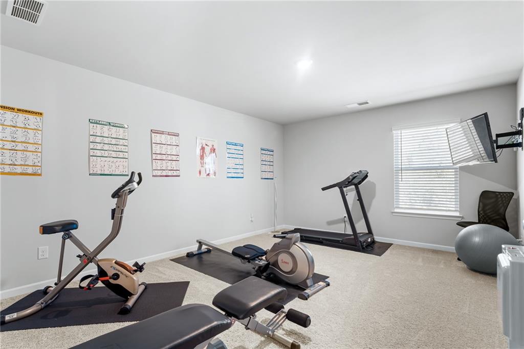 1476 Harlequin Way Stockbridge, GA 30281 - Photo 40 of 57 a view of a room with gym equipment
