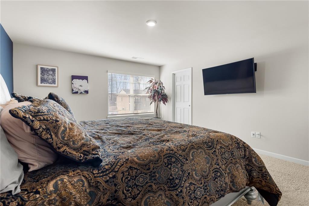 1476 Harlequin Way Stockbridge, GA 30281 - Photo 40 of 62 a bedroom with a bed and a flat screen tv