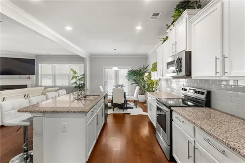 a kitchen with sink stove and refrigerator