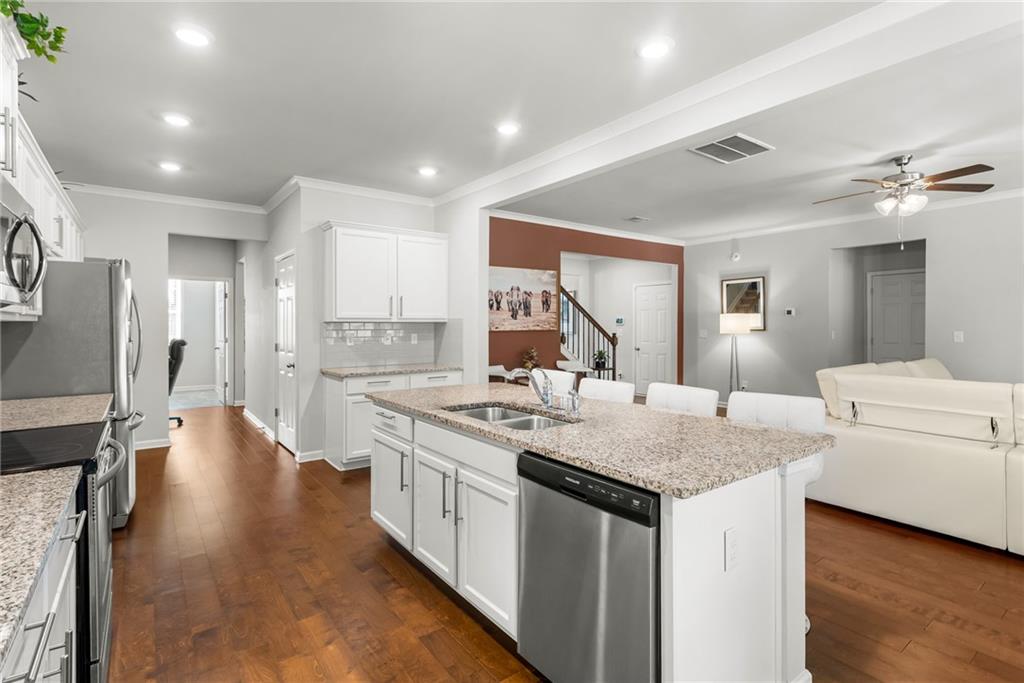 1476 Harlequin Way Stockbridge, GA 30281 - Photo 10 of 57 a kitchen with sink stove and refrigerator