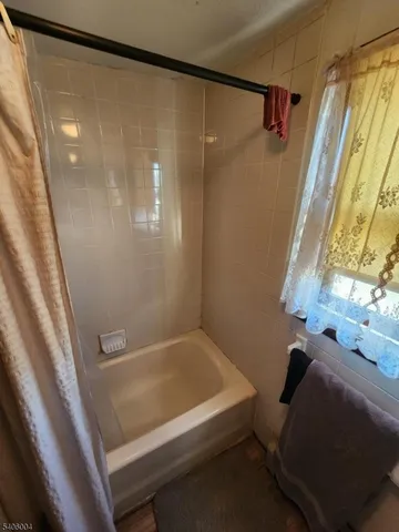 a bathroom with a bathtub and a shower