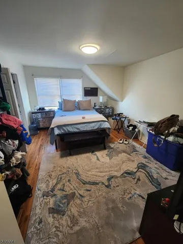 a bedroom with a bed and a large mirror