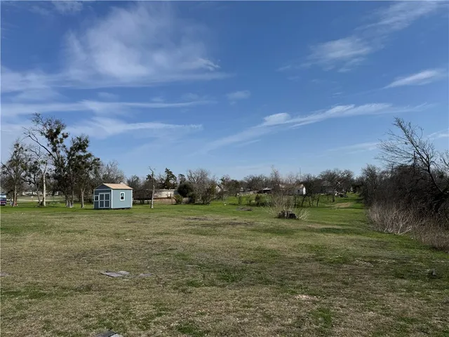 a big yard with lots of green space and trees