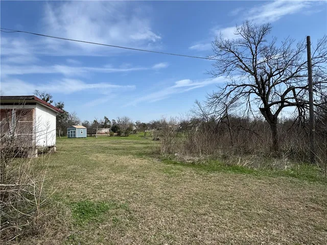 a view of a barn in the middle of a yard