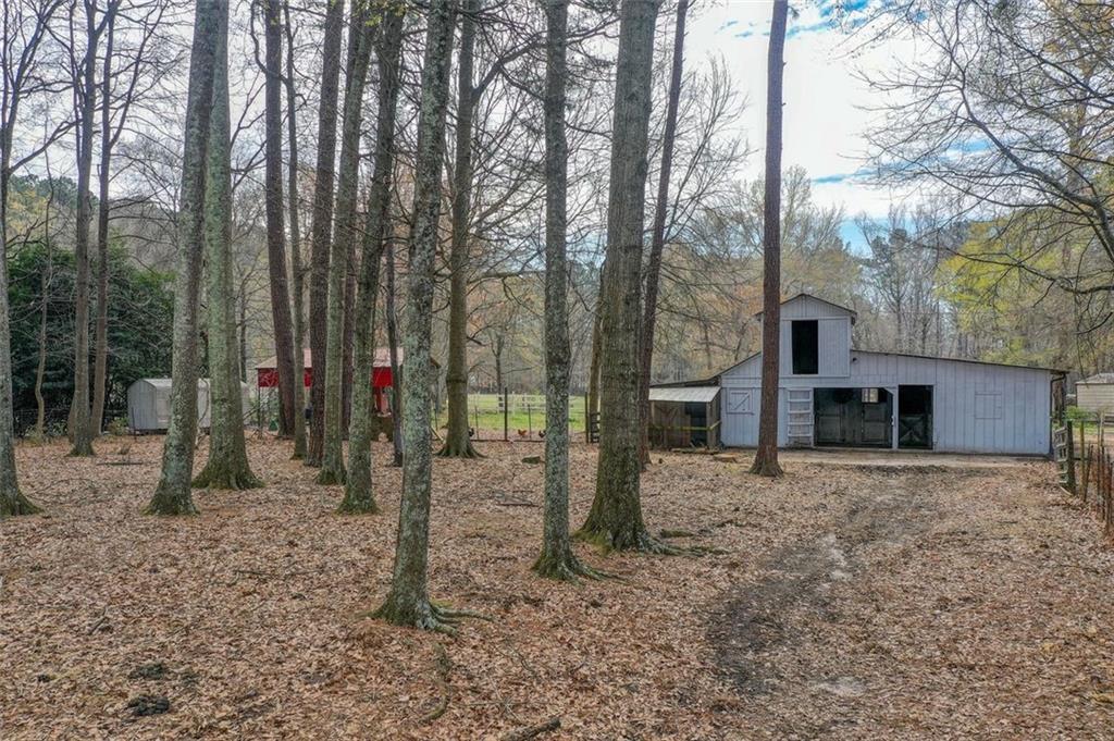 8345 Cleckler Road Palmetto, GA 30268 - Photo 17 of 41 a view of a house with a backyard and trees