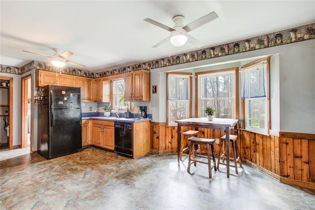 8345 Cleckler Road Palmetto, GA 30268 - Photo 26 of 41 a kitchen with stainless steel appliances granite countertop a refrigerator a sink a stove and white cabinets with wooden floor