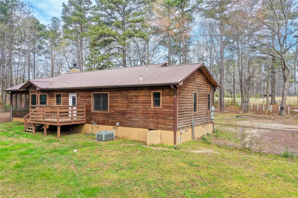 8345 Cleckler Road Palmetto, GA 30268 - Photo 30 of 41 a backyard of a house with table and chairs