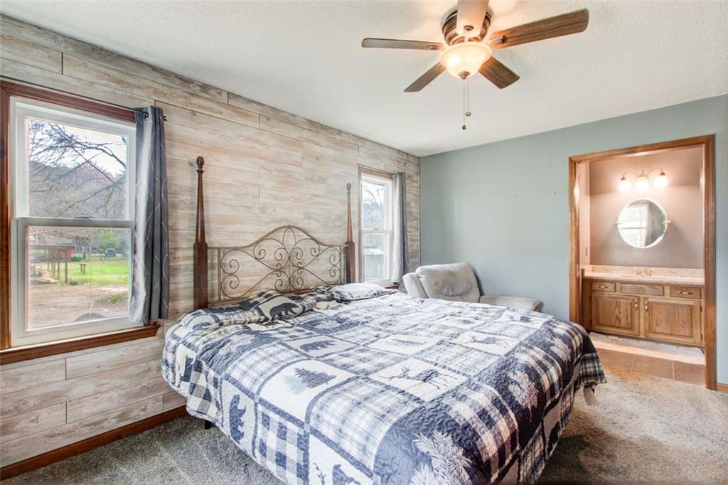 8345 Cleckler Road Palmetto, GA 30268 - Photo 36 of 41 a bedroom with a large bed and a chandelier fan