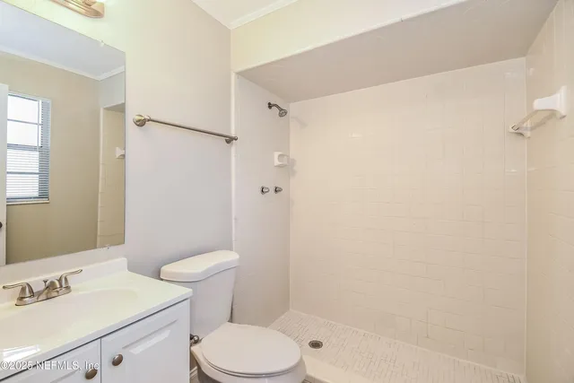 a white toilet sitting next to a bath tub shower
