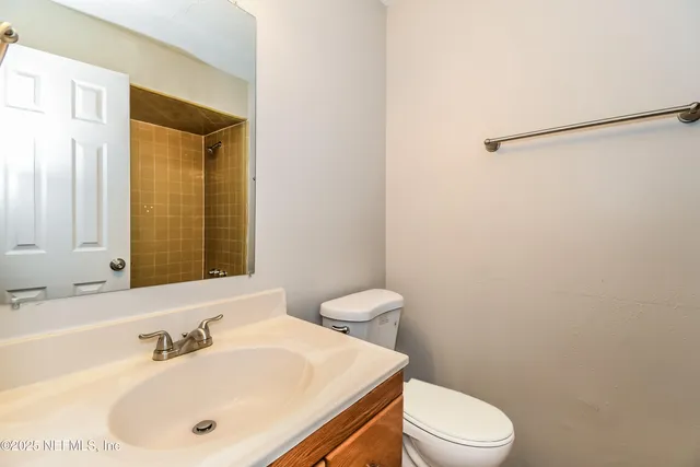 a bathroom with a sink a toilet and mirror