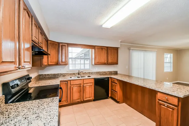 a kitchen with a sink stove and cabinets