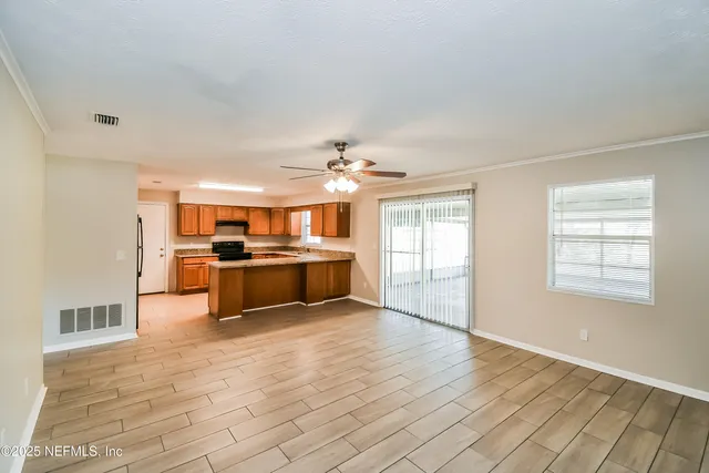 a view of a kitchen with kitchen island wooden floor and window