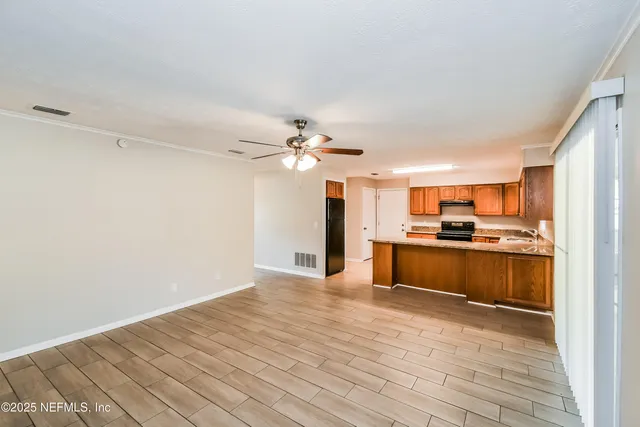 a view of a kitchen with a sink and a refrigerator