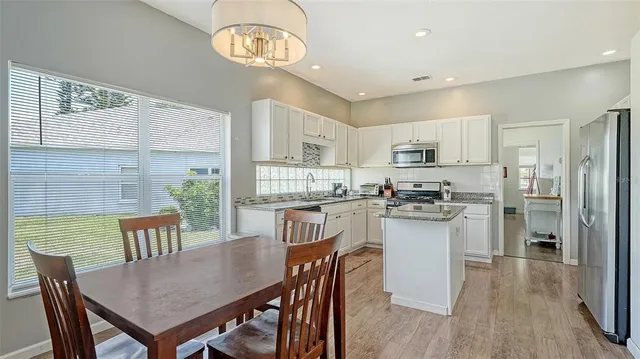 a kitchen with stainless steel appliances granite countertop a sink stove microwave and cabinets