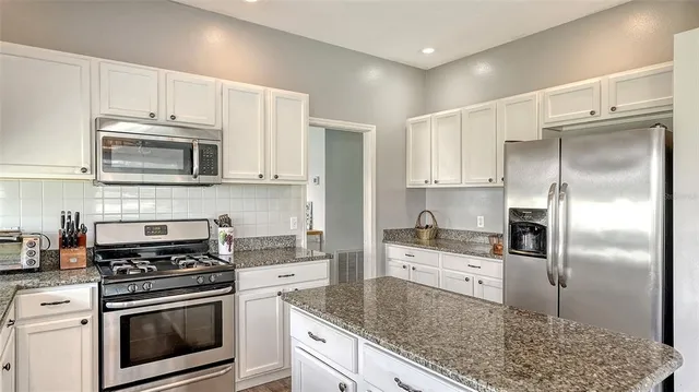 a kitchen with granite countertop lots of counter top space