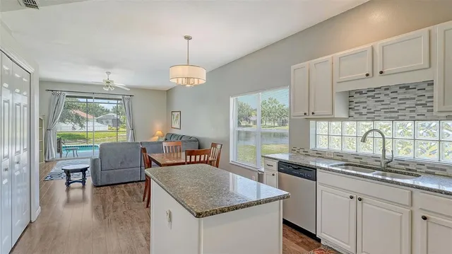 a dining room with furniture a chandelier and wooden floor