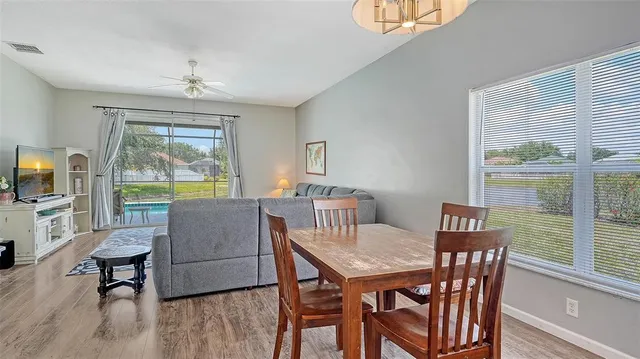 a living room with furniture a chandelier and a window