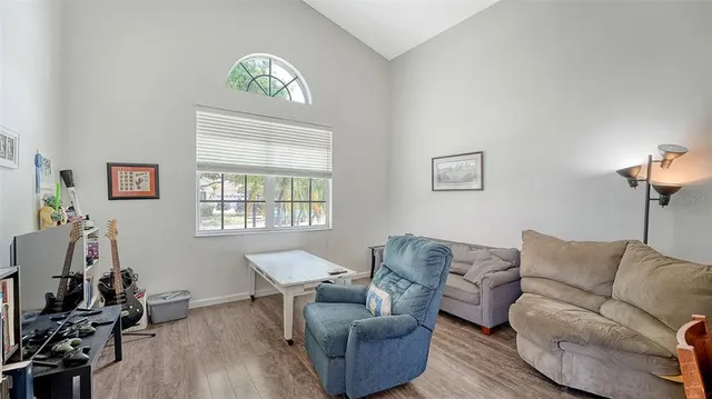 a bedroom with a bed table and a lamp