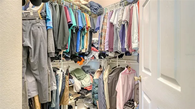 a bathroom with a granite countertop sink a mirror and a bathtub