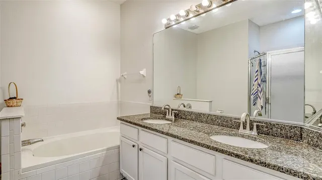a bathroom with a glass shower door and a mirror