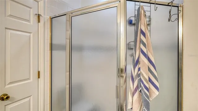 a bedroom with a bed and a book shelf