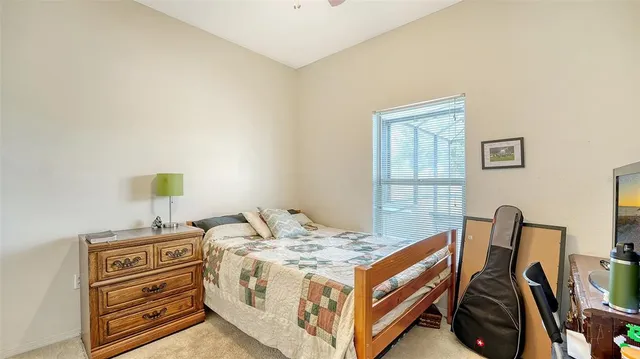 a bedroom with a bed and book shelf
