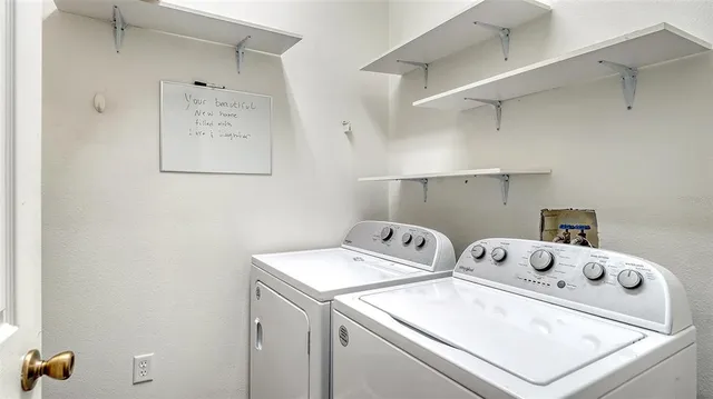 a swimming pool with lawn chairs and outdoor view