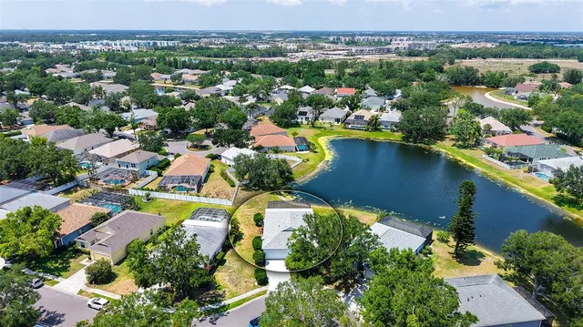 an aerial view of a houses with a lake view