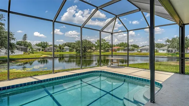 an aerial view of a house with a swimming pool and garden