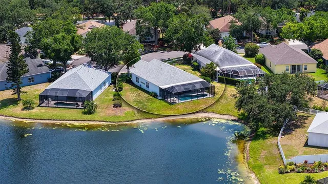 an aerial view of a house with a lake view