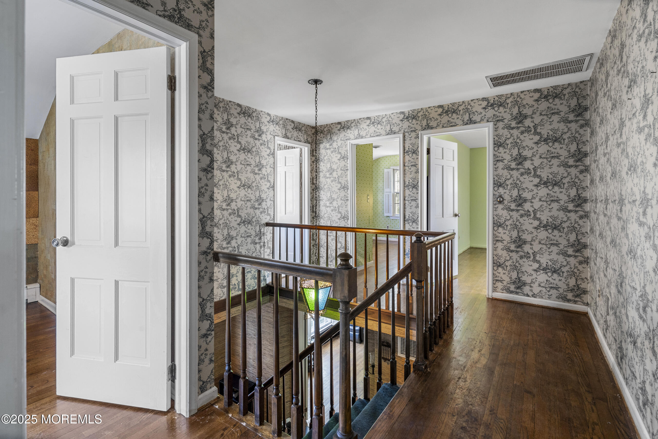 647 Valley Road Brielle, NJ 08730 - Photo 17 of 38 a view of hallway with wooden floor and stairs