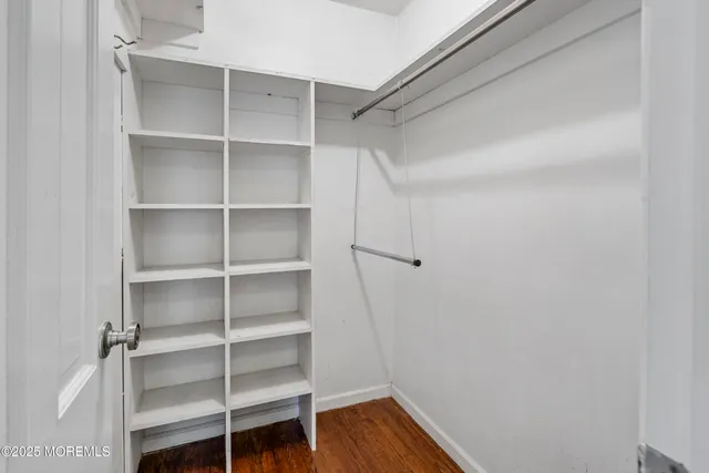 a view of walk in closet with empty racks