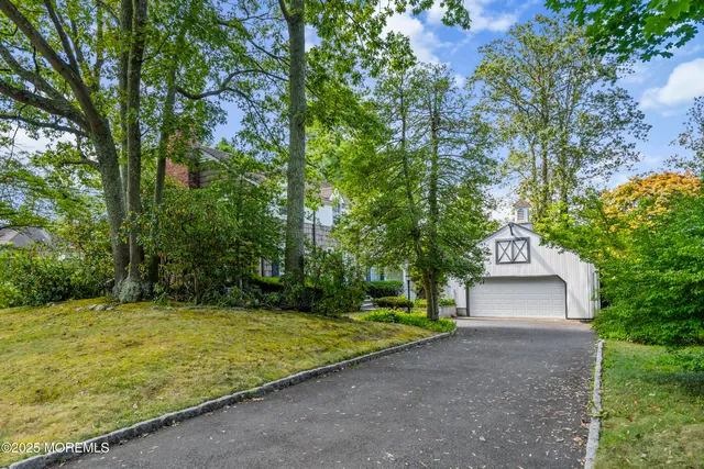 a view of a large trees in front of a house