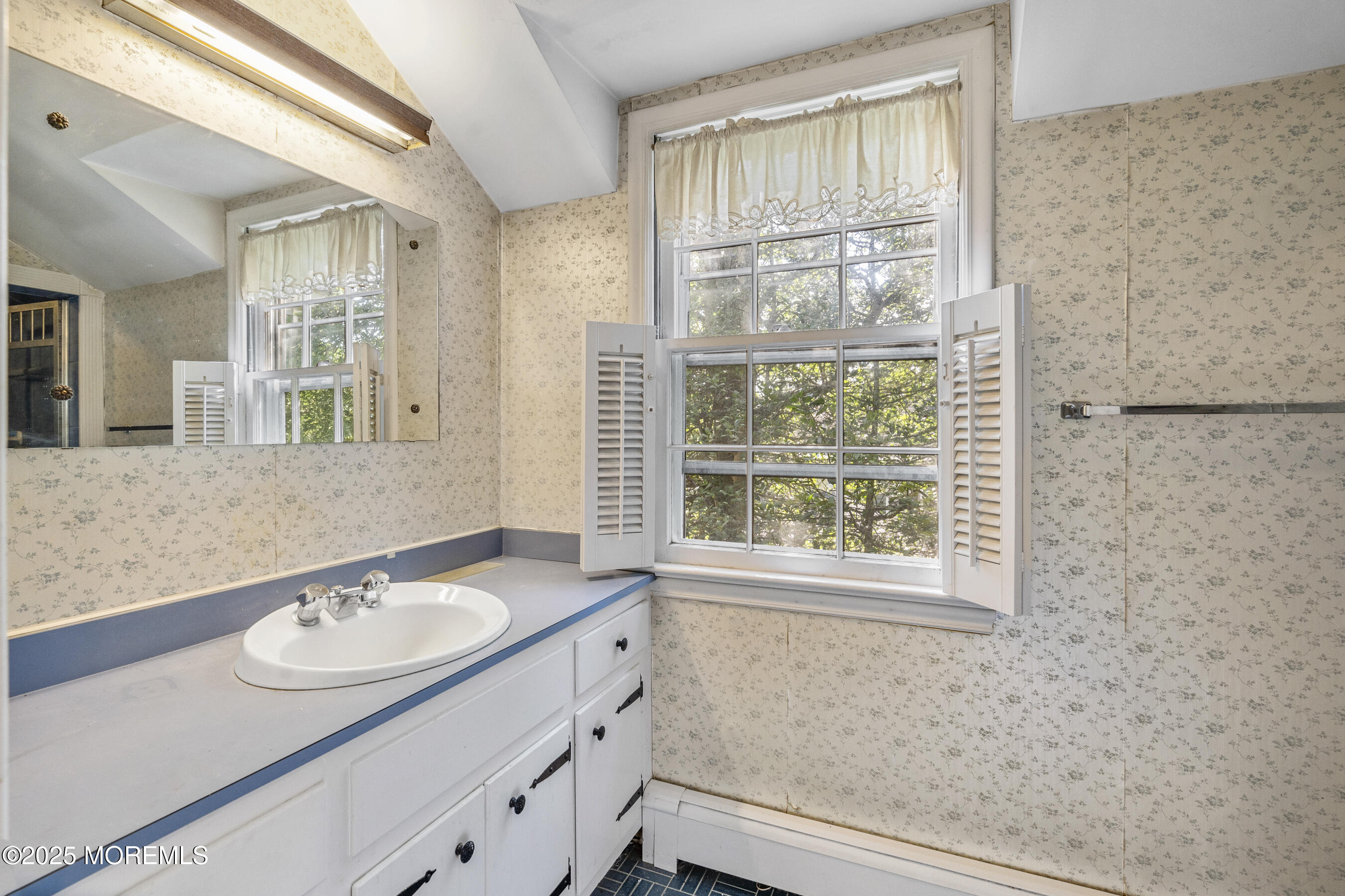 647 Valley Road Brielle, NJ 08730 - Photo 21 of 38 a bathroom with a sink and a mirror