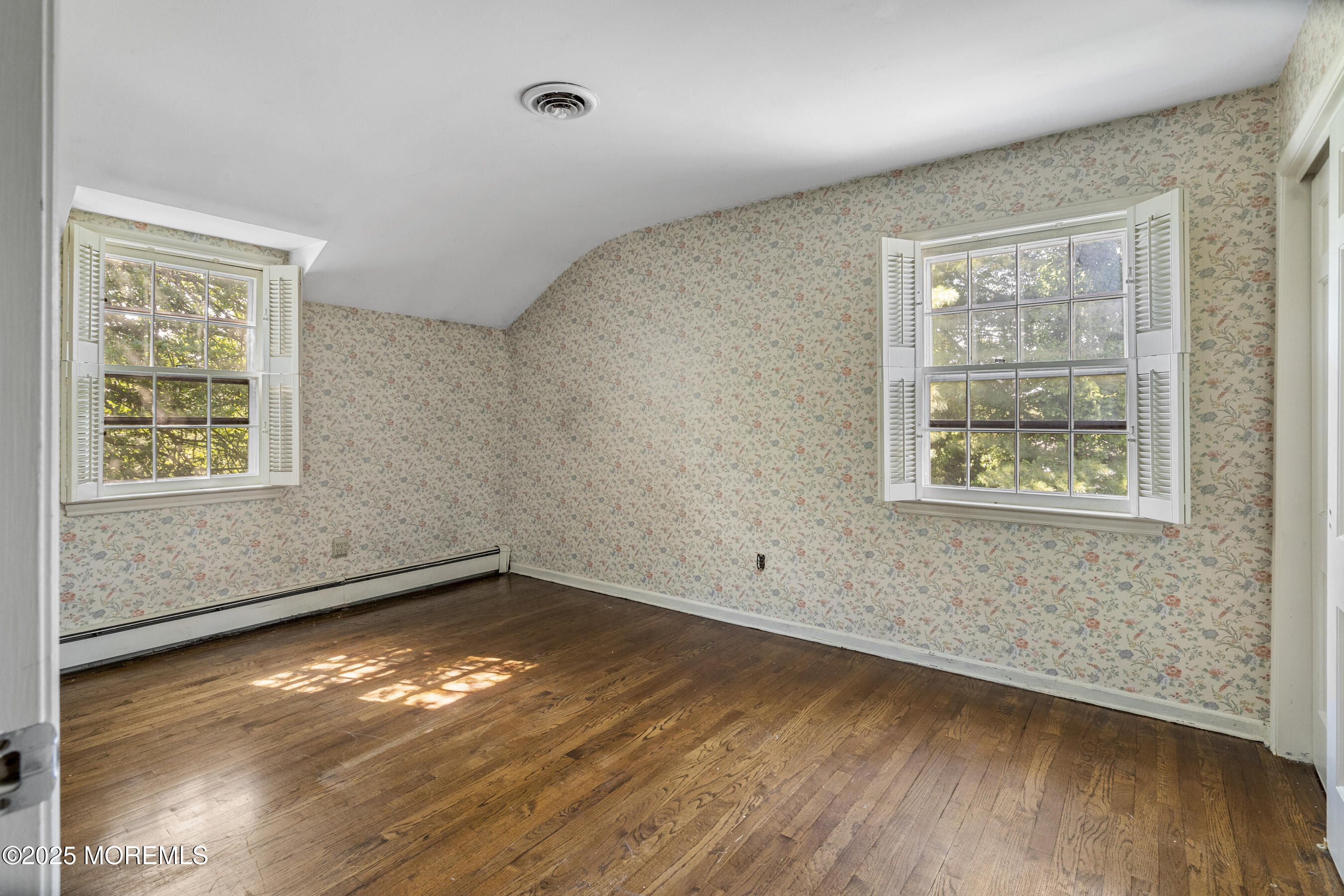 647 Valley Road Brielle, NJ 08730 - Photo 23 of 38 an empty room with wooden floor and windows