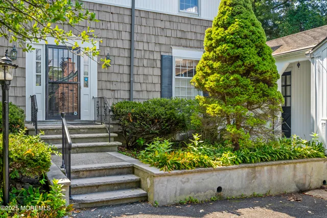 a front view of a house with a garden