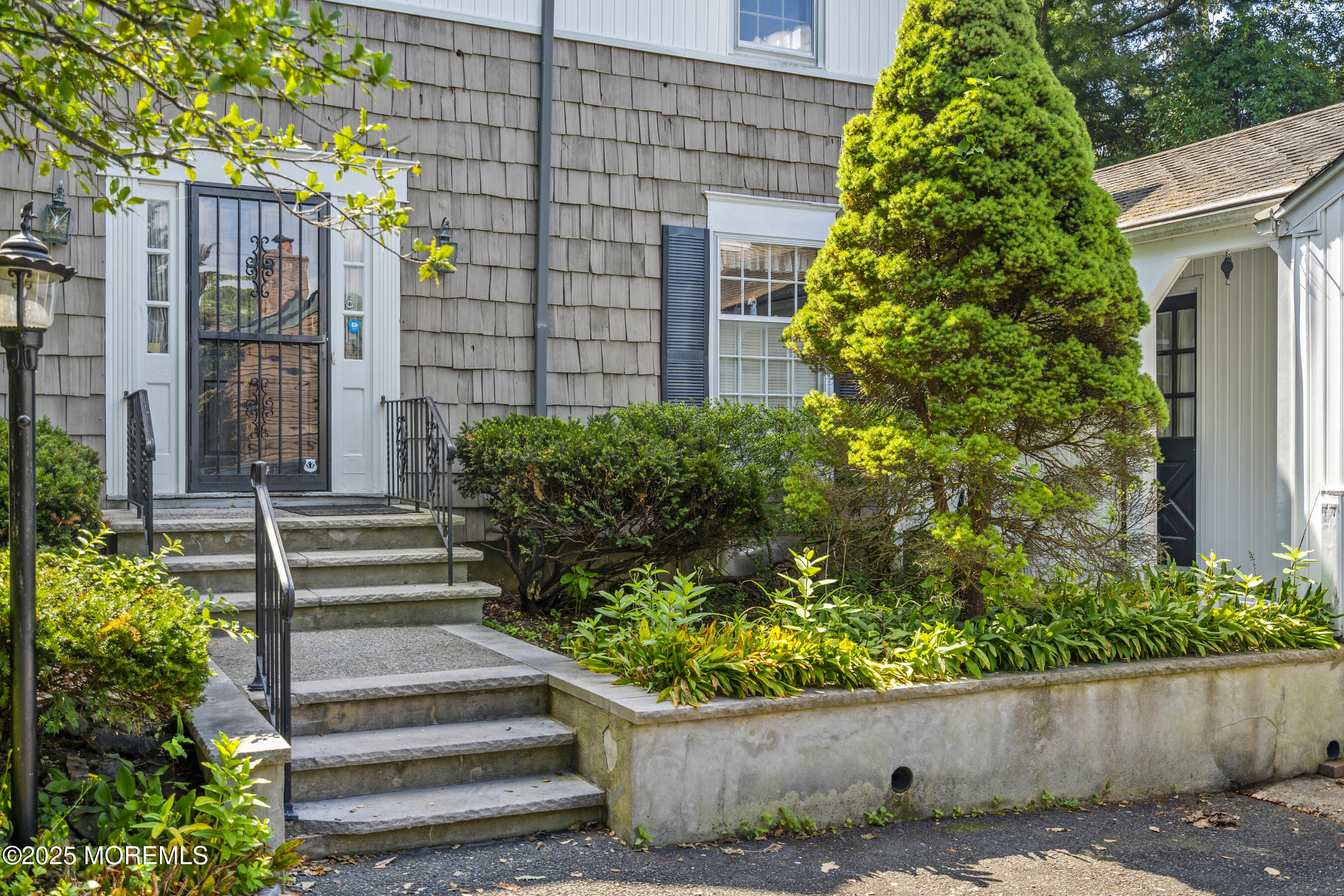 647 Valley Road Brielle, NJ 08730 - Photo 4 of 38 a front view of a house with a garden