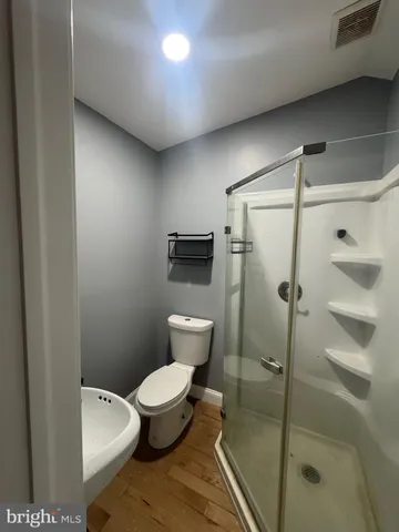 a bathroom with a toilet and a shower