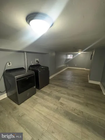 an empty room with wooden floor and door