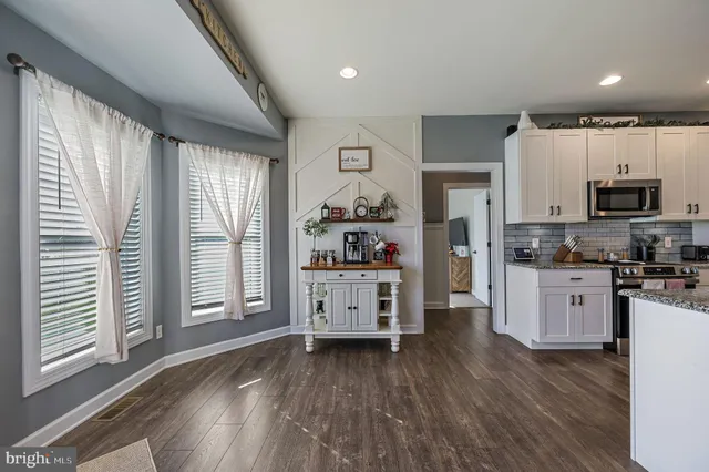 a kitchen with stainless steel appliances a refrigerator sink and cabinets
