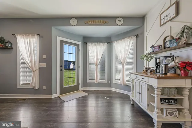 a view of an entryway with wooden floor