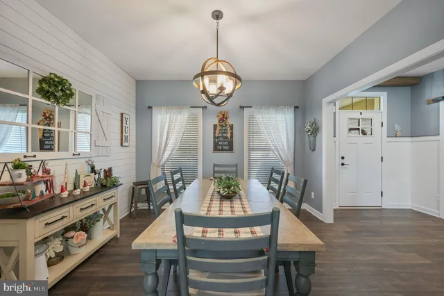 a view of a dining room with furniture wooden floor and a chandelier