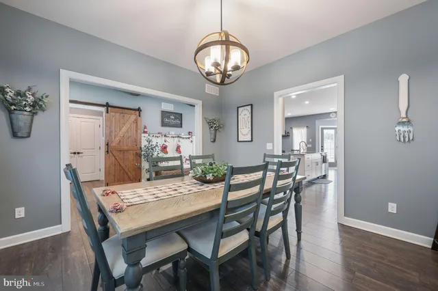 a view of a dining room with furniture wooden floor and a chandelier