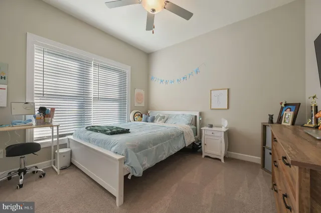 a bedroom with a bed and a desk