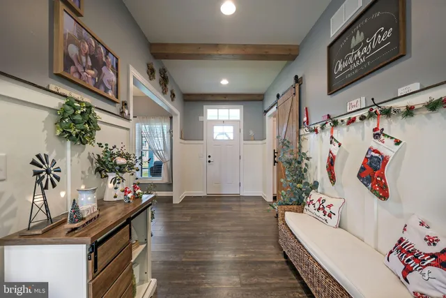 a hallway with a flower pot and a couch