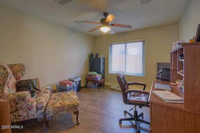 an empty room with a window and a ceiling fan